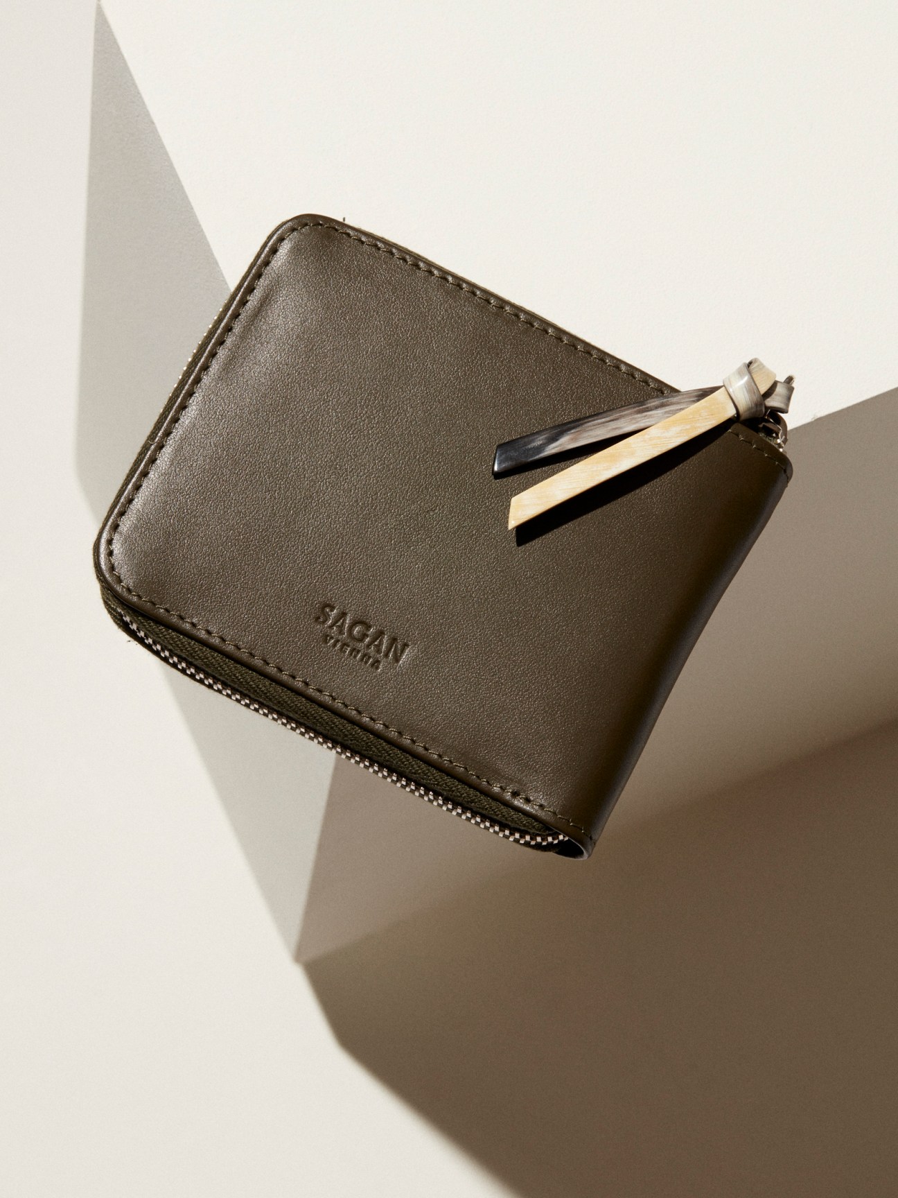 Brown leather wallet by Sagan Vienna with zipper closure and key ring attachment