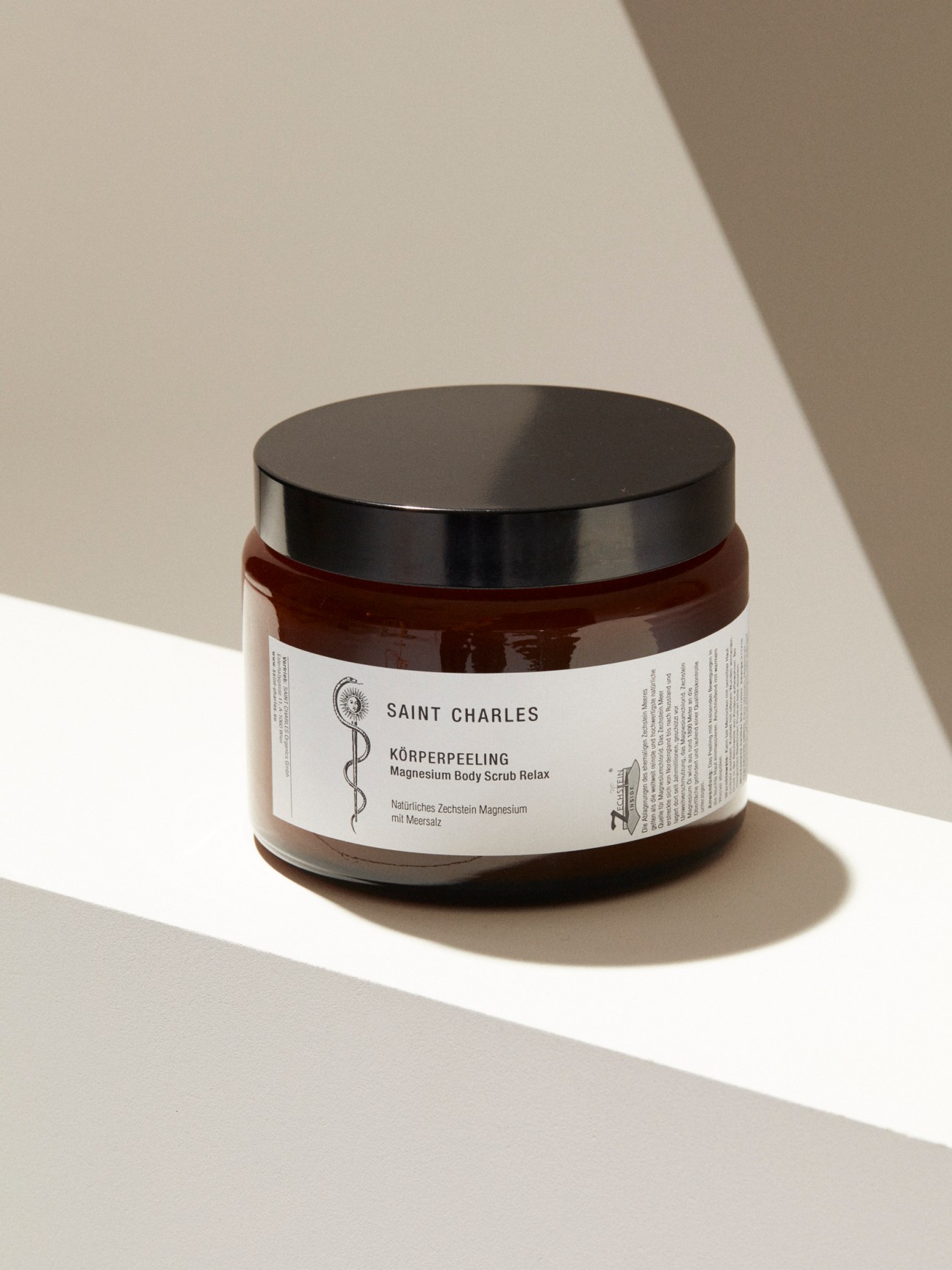 Saint Charles Apothecary body scrub in dark amber glass jar with black lid and white label