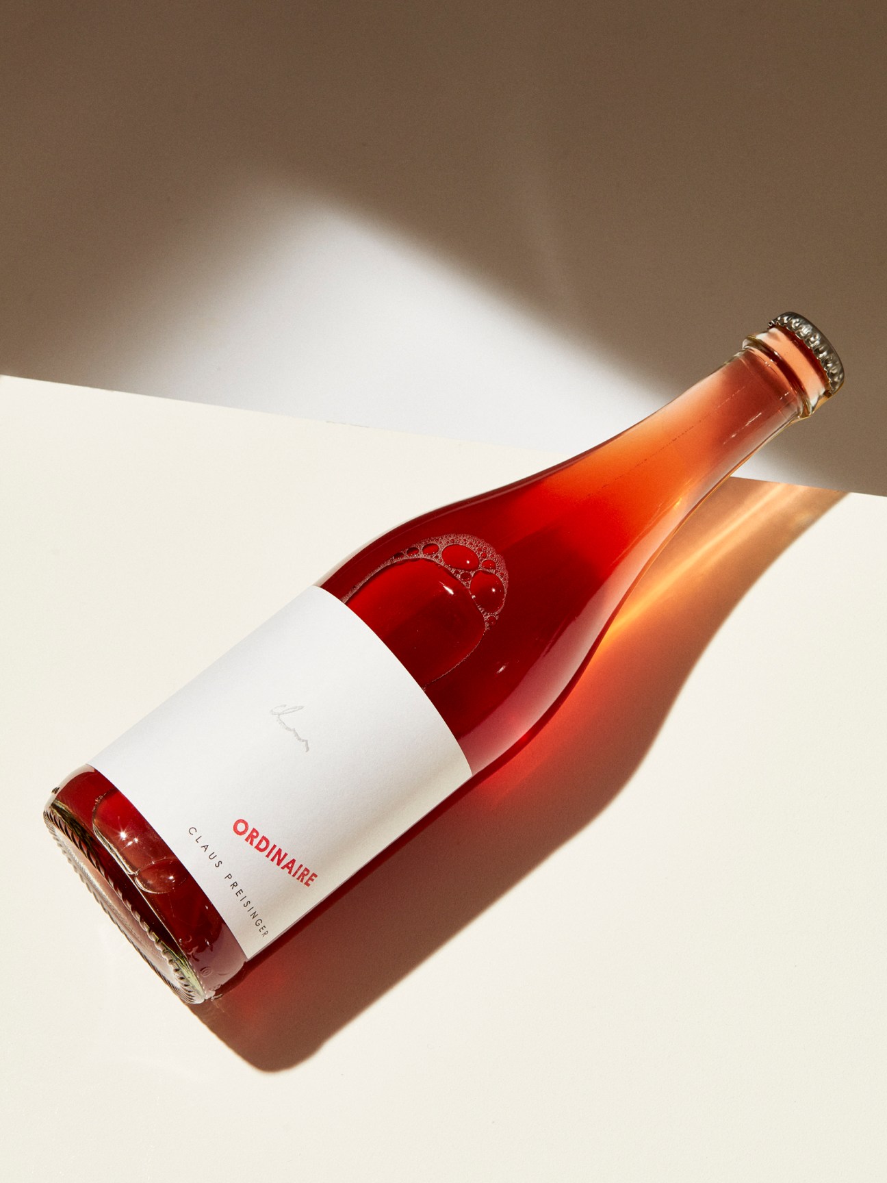 Pinot noir wine bottle by Claus Preisinger with white label and cork top