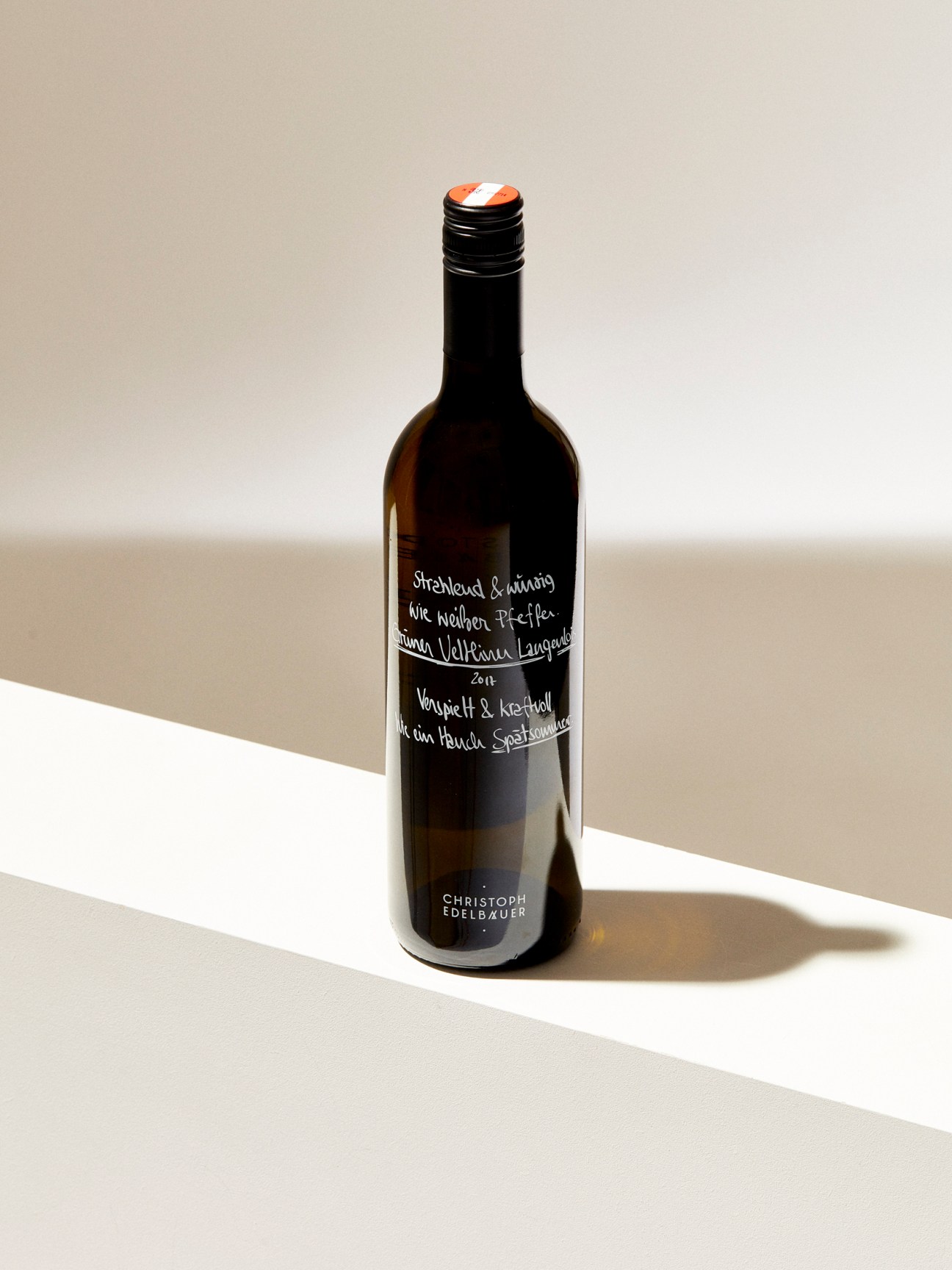 Dark wine bottle with handwritten white text label from Christoph Edelbauer winery