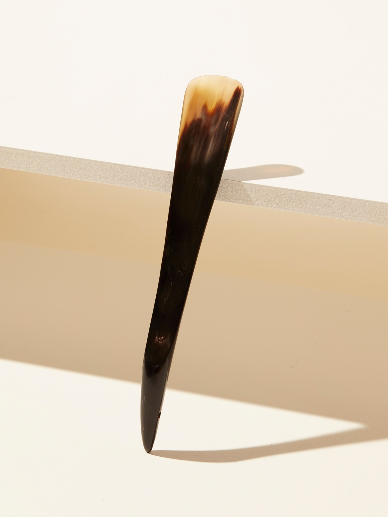 Alden shoe horn with dark horn material transitioning from black to light tan at the curved end