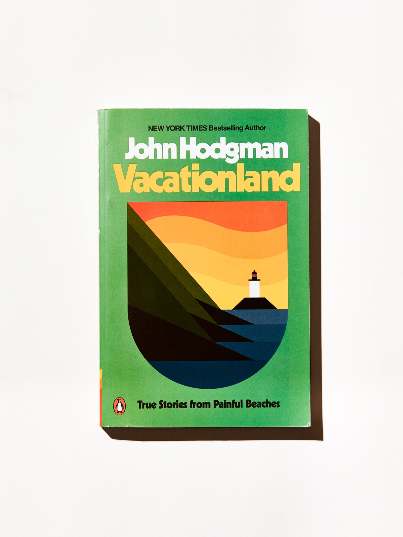 Vacationland book cover by John Hodgman with green background and coastal lighthouse illustration