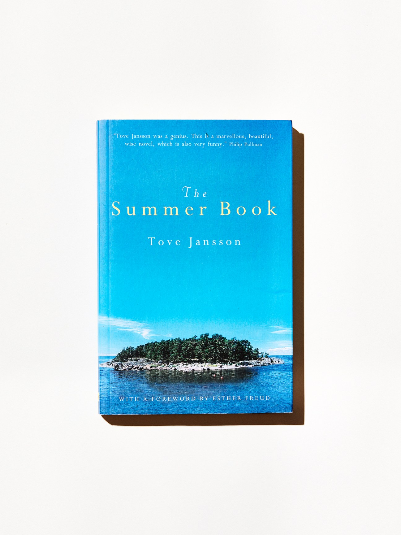 The Summer Book cover by Tove Jansson featuring blue sky and small forested island surrounded by water