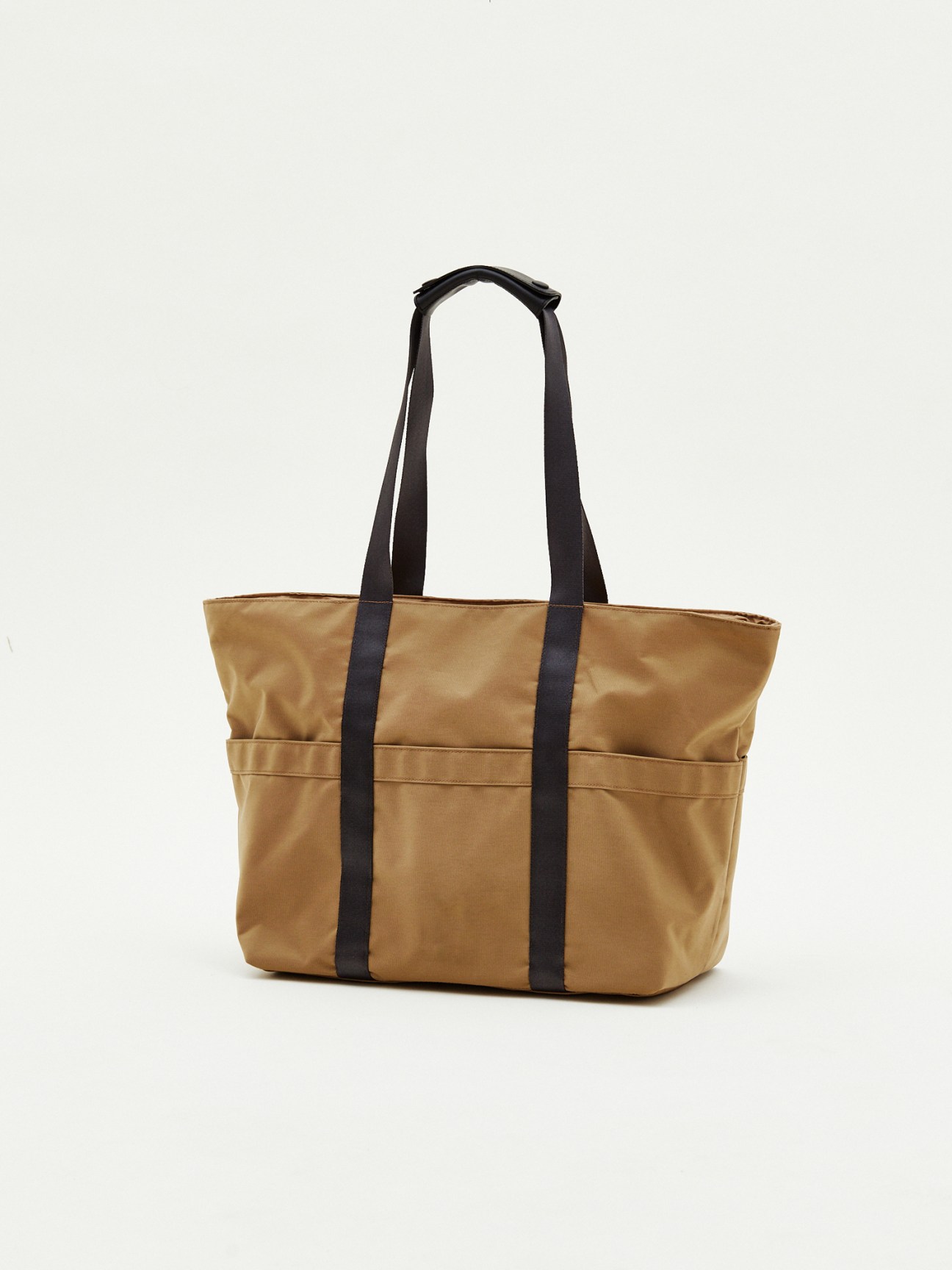 Trolly tote bag by Monocle in beige canvas with black handles and straps.