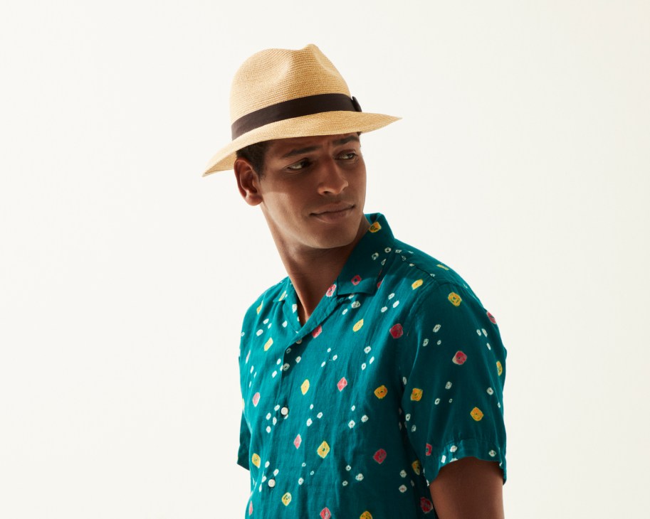 Man wearing teal patterned shirt by Gitman Vintage and straw hat by Grevi from Trunk