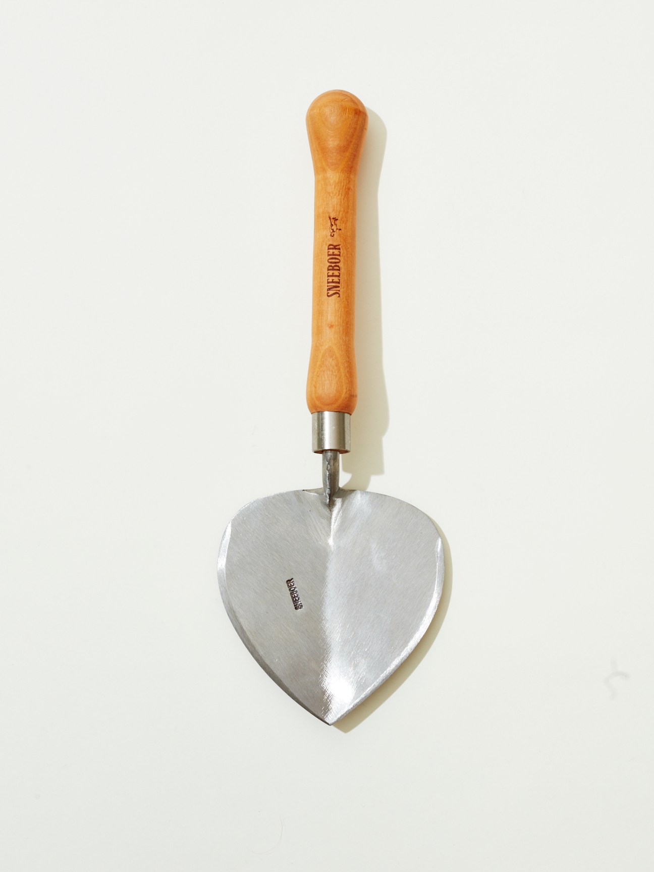 Stainless steel heart-shaped trowel with wooden handle by Sneeboer