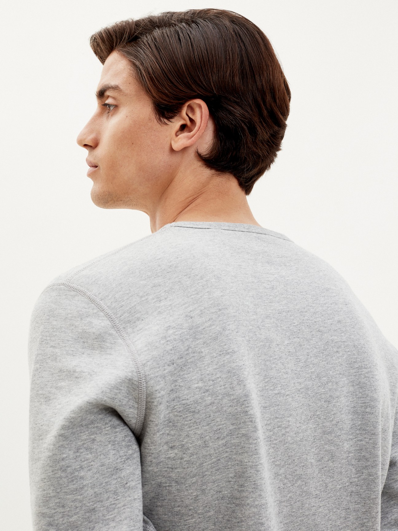 Trunk x Monocle classic round-neck sweatshirt in grey melange worn by model shown from behind