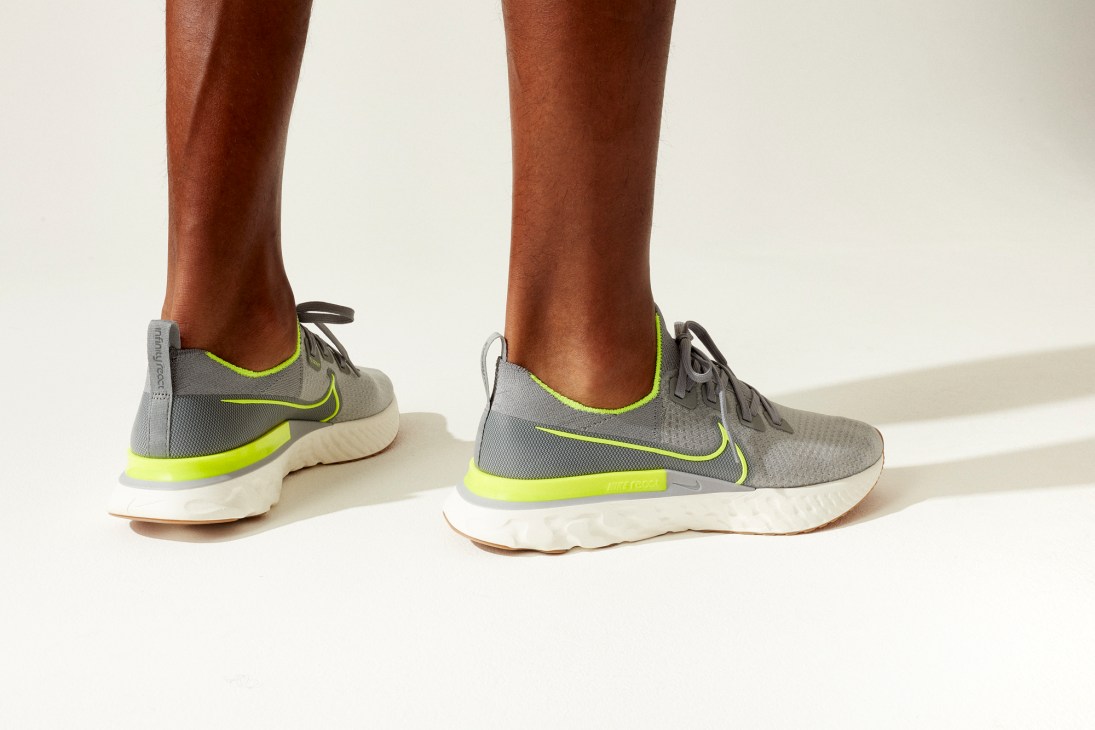 Nike React Infinity Run Flyknit running shoes in grey with bright green accents on feet