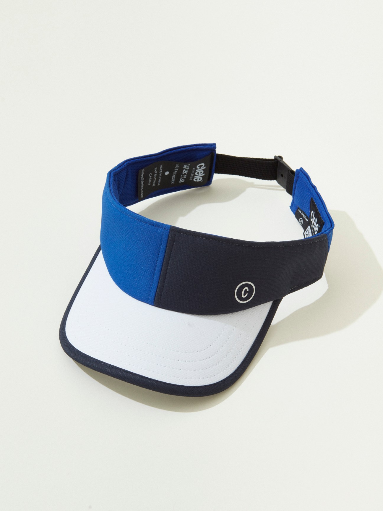 White running visor with blue and black trim on white background