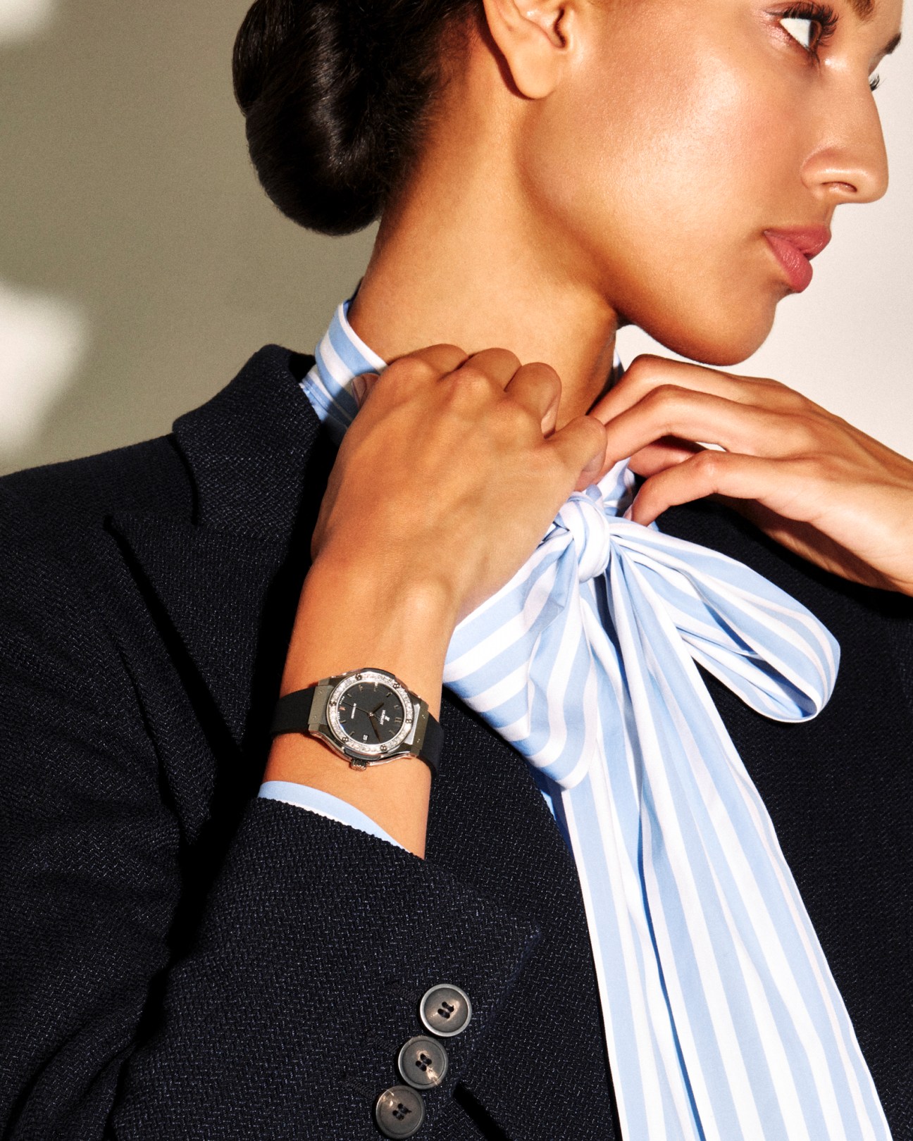 Woman in Giorgio Armani jacket and Lardini shirt wearing Hublot Classic Fusion Titanium Diamonds watch.