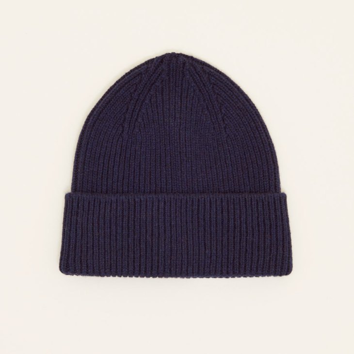 Navy ribbed cashmere beanie photographed against neutral background