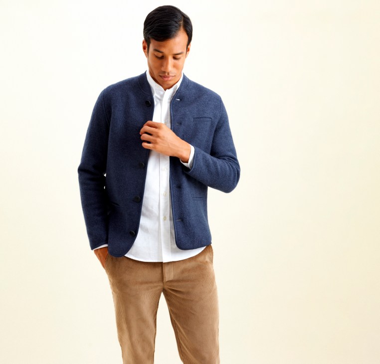 Navy alpine felt jacket by Glücklich x Monocle with traditional alpine styling worn by model