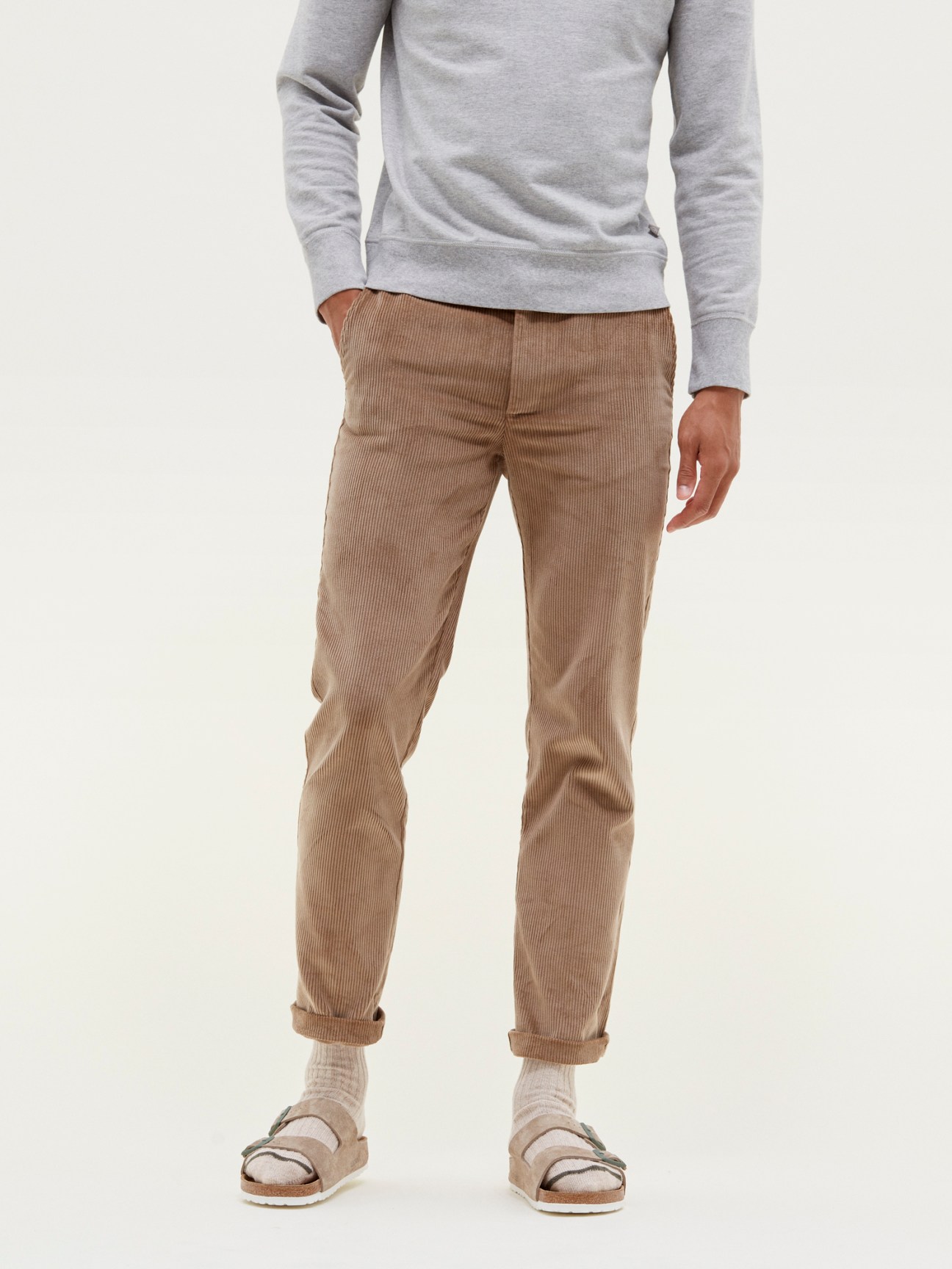 De Bonne Facture x Monocle easy trousers in fine caramel corduroy worn with a grey sweatshirt.
