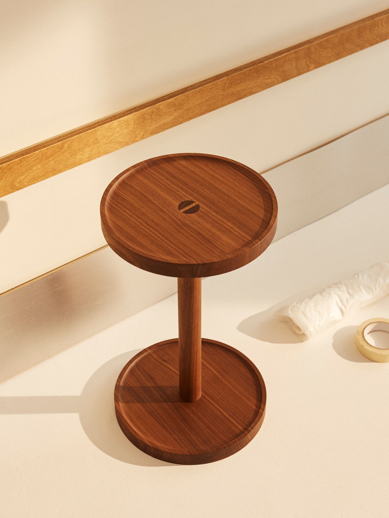 Two-tier wooden side table with circular shelves connected by central post, showing natural wood grain