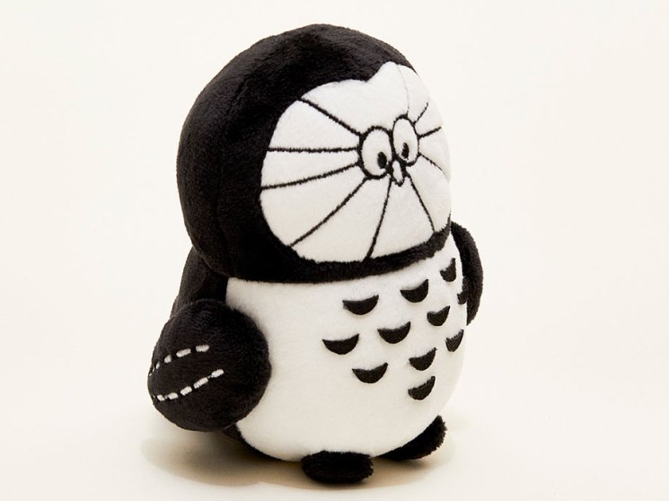 White plush owl toy with black accents and embroidered features