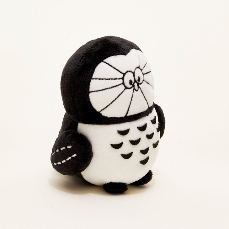 White plush owl toy with black accents and embroidered features