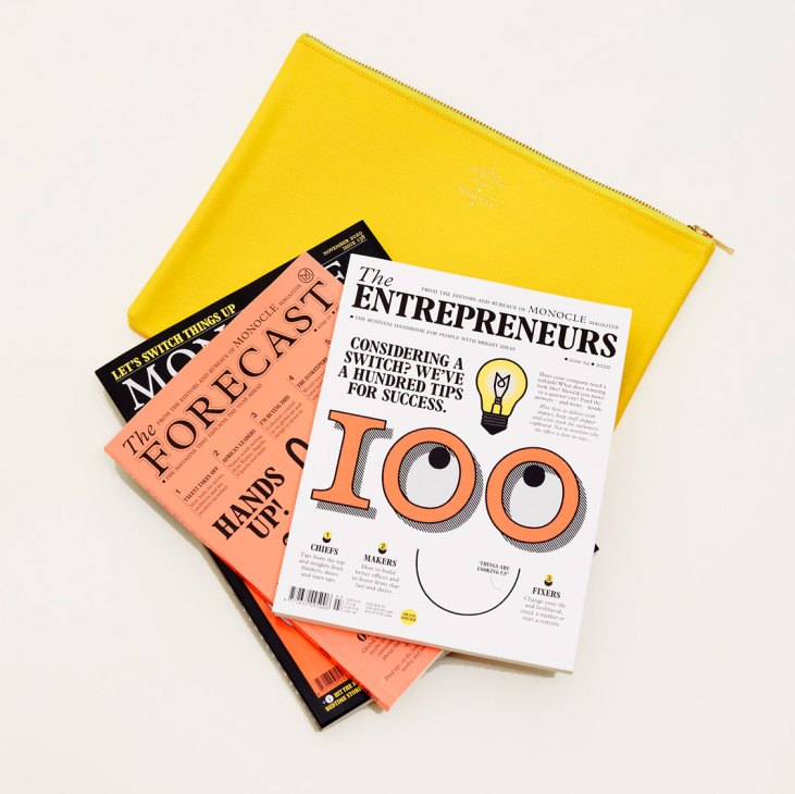 Yellow leather pouch containing Monocle magazines and branded materials from starter gift set