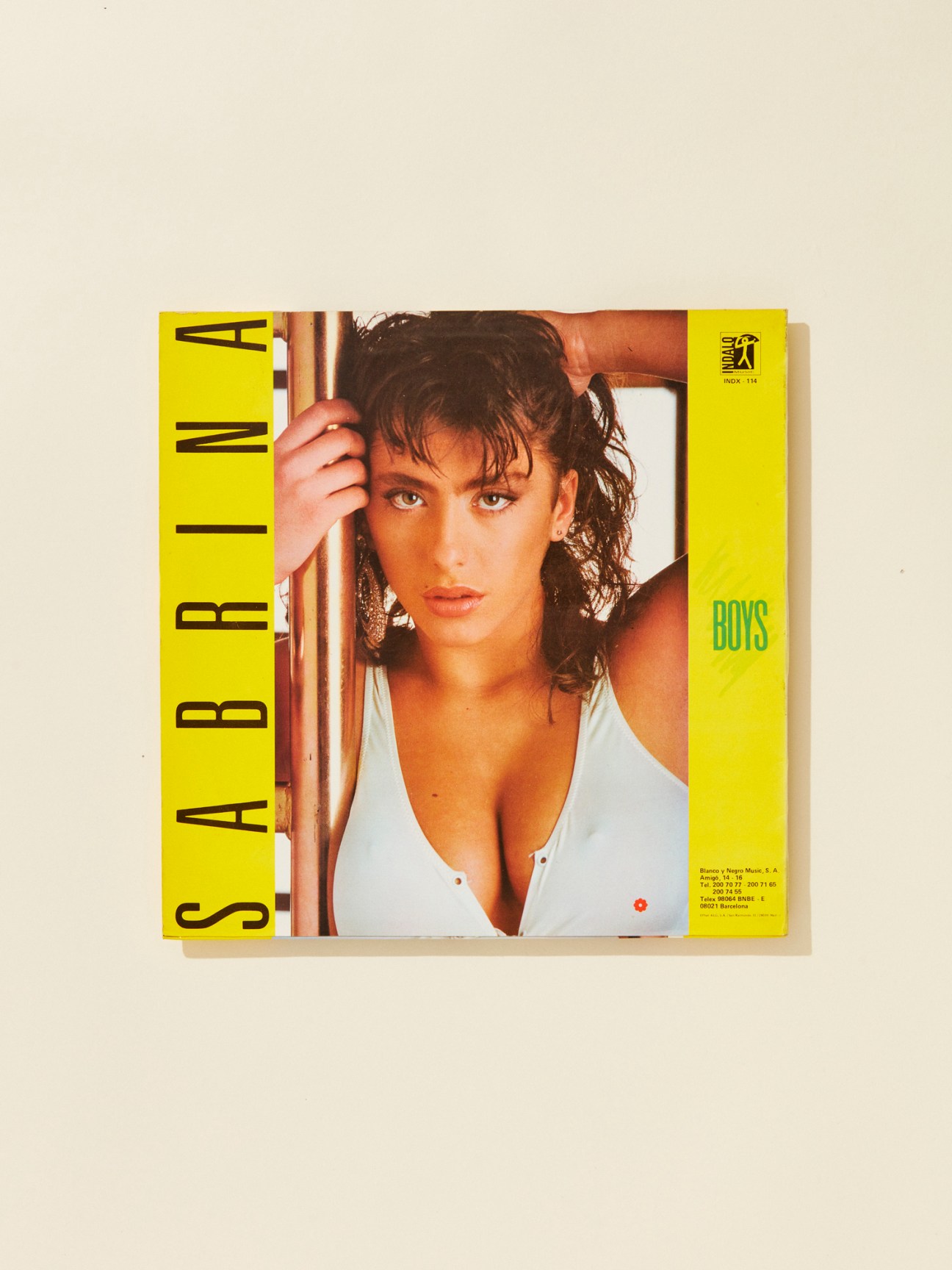 Sabrina's 1987 album cover 'Boys' with bright yellow borders and the artist's portrait in the center.
