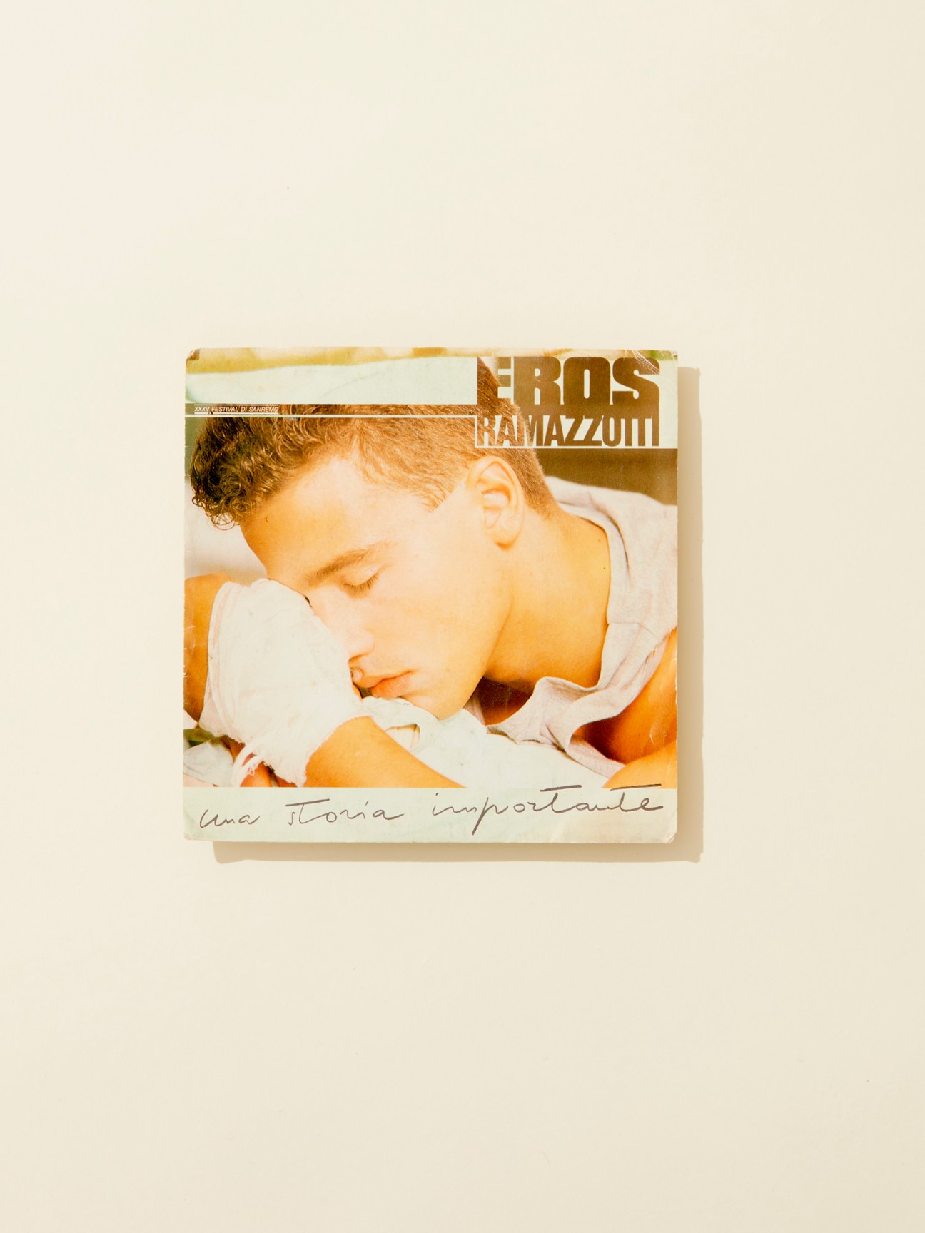 Eros Ramazzotti album cover 'Una Storia Importante' from 1985 showing a young man in warm tones.