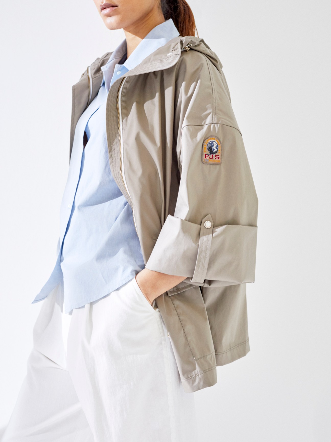 Person wearing a Parajumpers jacket over an APC shirt with Ports 1961 trousers in a fashion styling