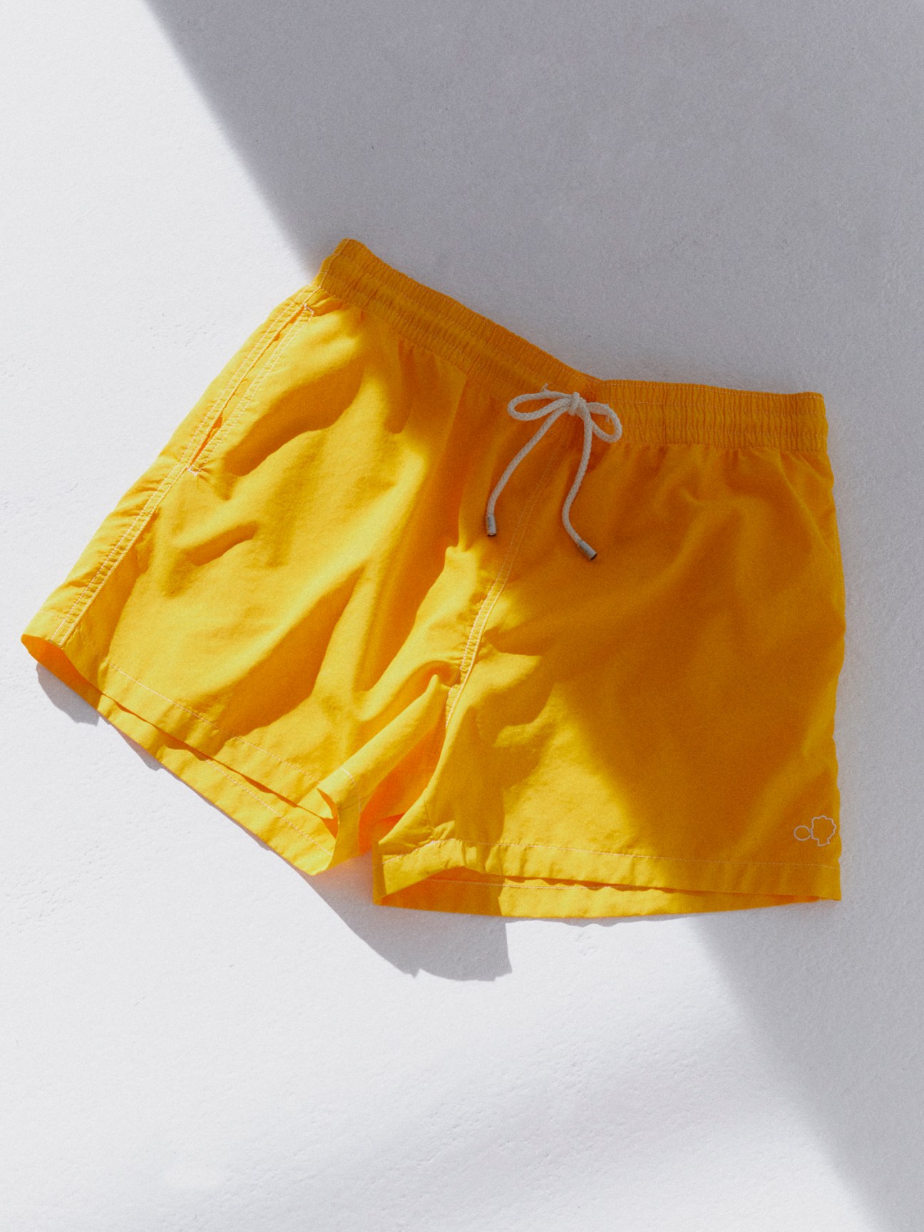 Yellow swim shorts with white drawstring from Barcelona-based Arrels swimwear brand