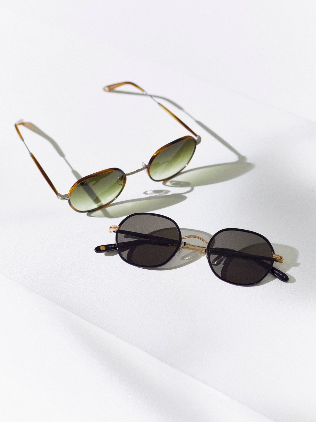 Two pairs of Norfolk sunglasses by Garrett Leight California Optical with tortoiseshell and dark frames