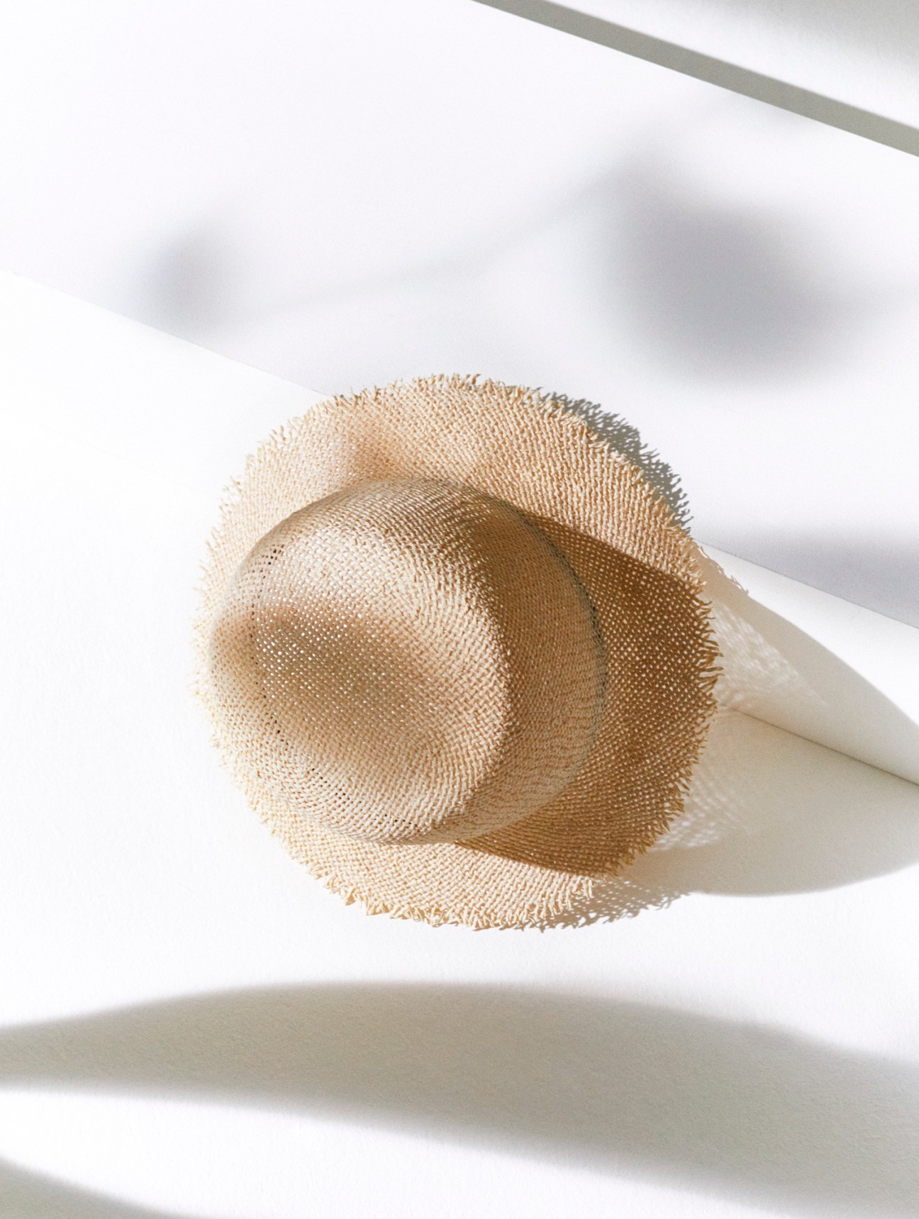 Light colored woven bucket hat with wide brim and natural texture