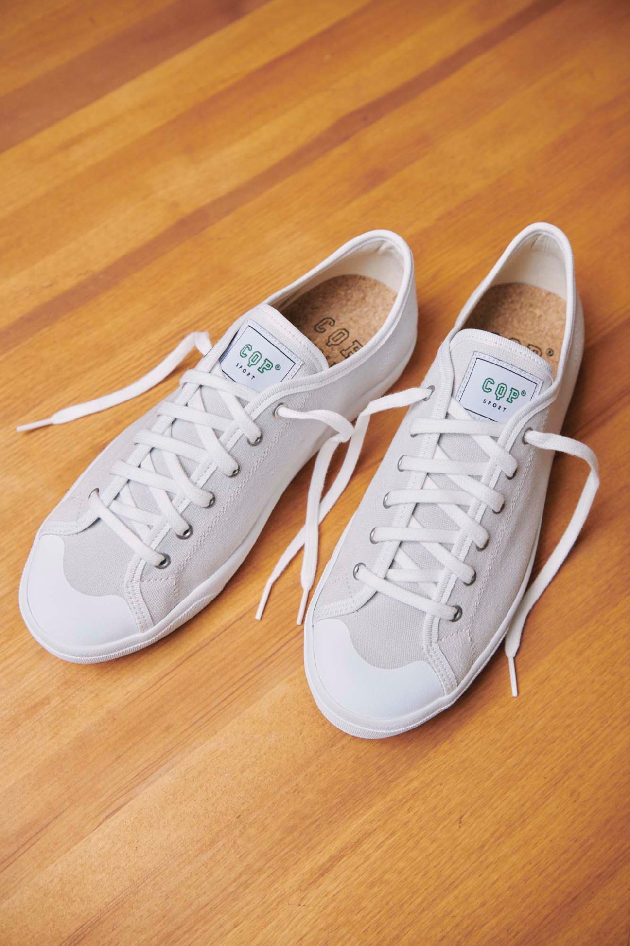 CQP's Clava trainers in white and beige on wooden floor showing retro styling