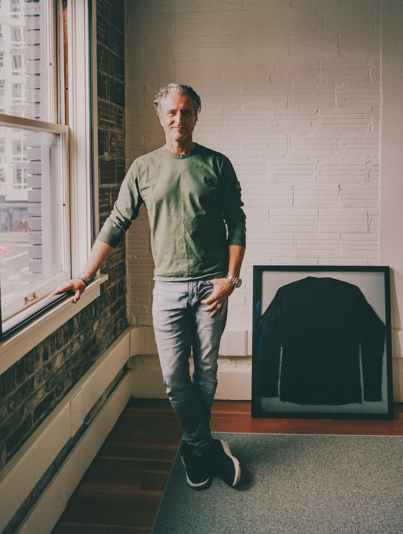 Omorpho co-founder Stefan Olander standing by windows in casual clothing with framed artwork
