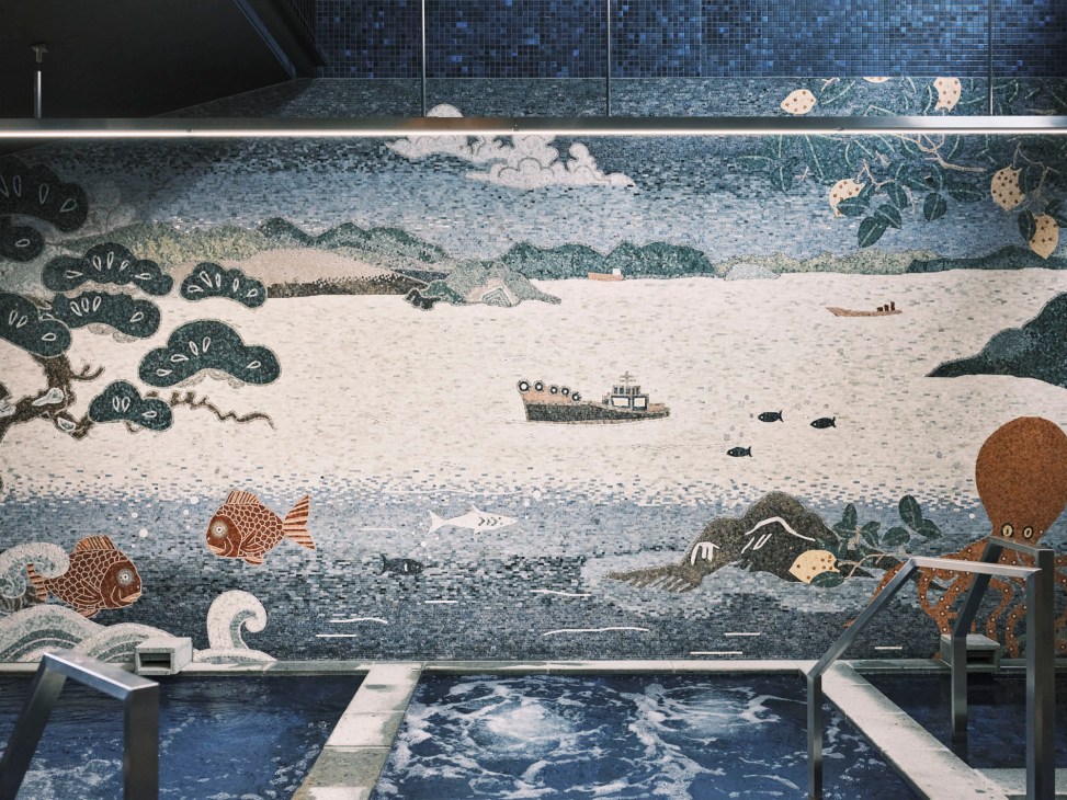 Detailed mosaic artwork featuring underwater scene with fish, boat, octopus and marine life in blue and earth tones