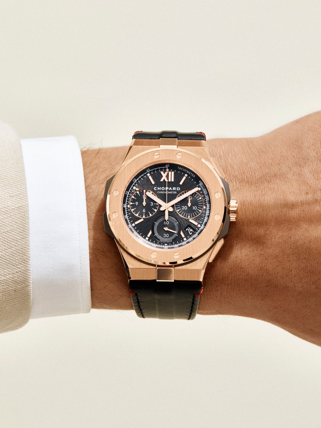 Alpine Eagle chronograph watch by Chopard with rose gold case and black dial worn on wrist