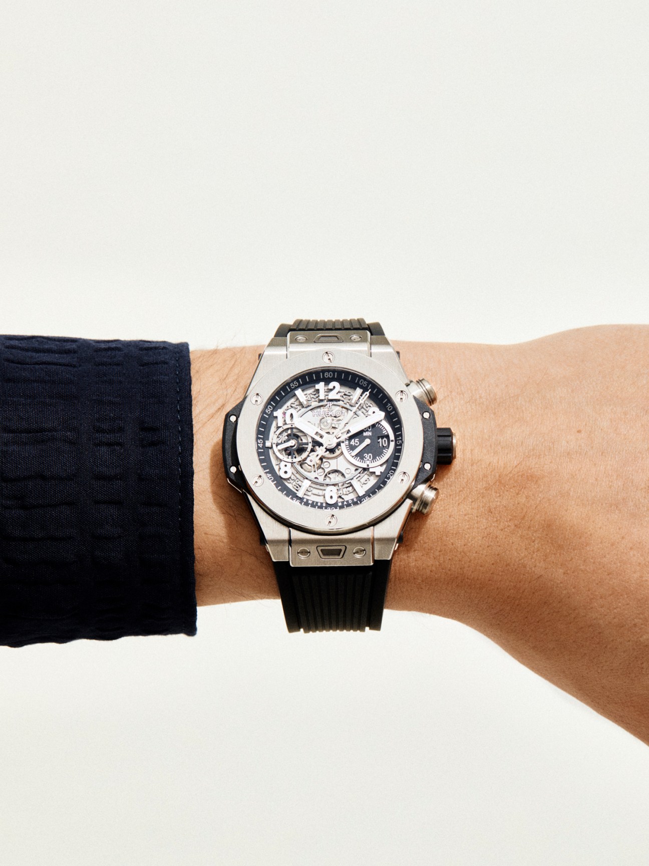 Big Bang Unico watch by Hublot worn on wrist showing skeletal dial and titanium case