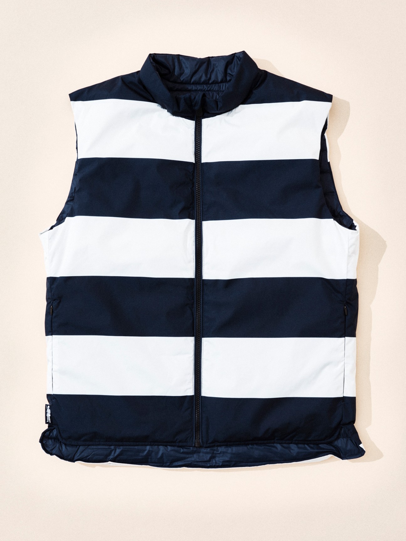 Navy and white striped vest with full zip displayed on neutral background