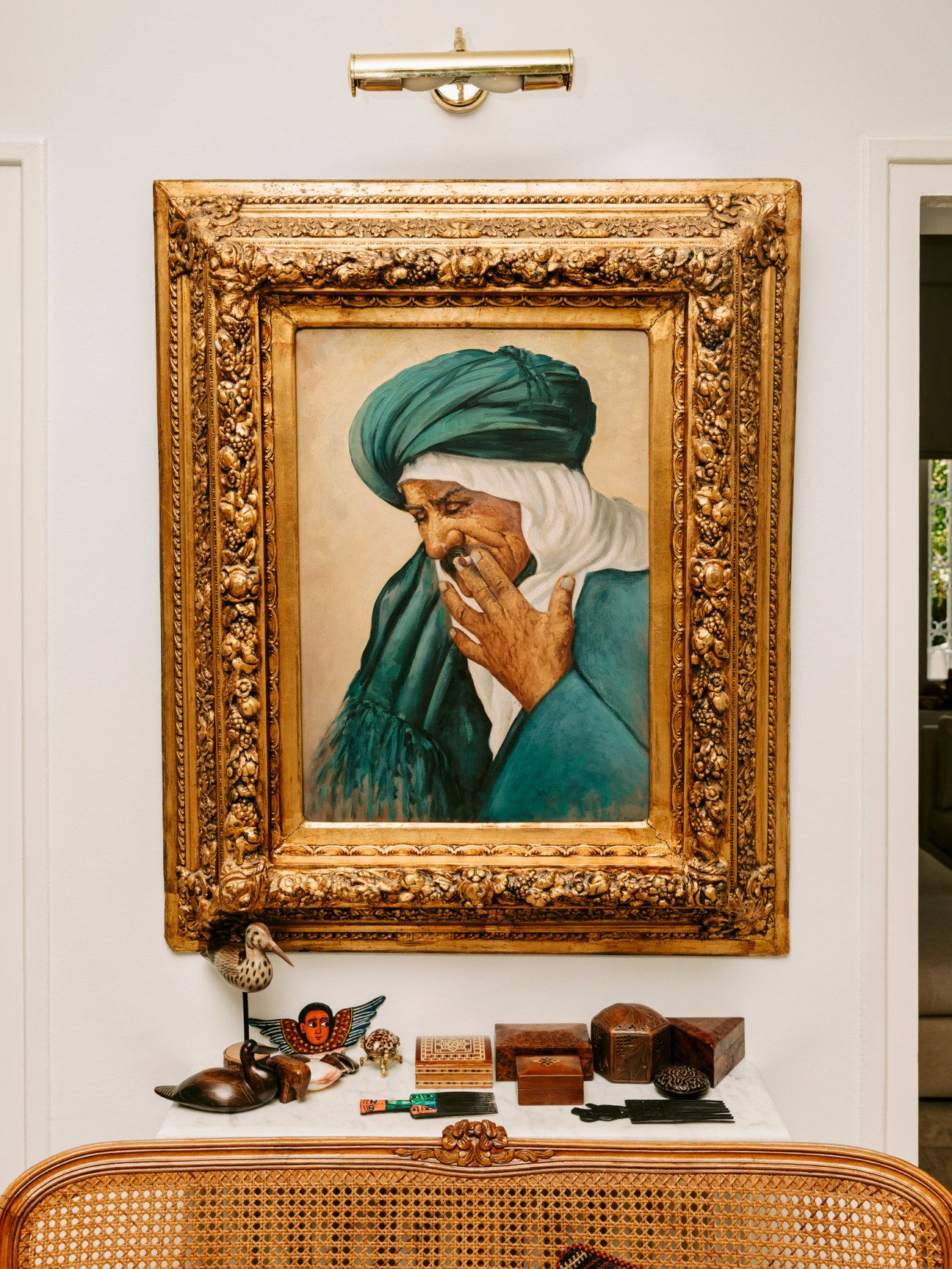 Interior of restored villa with framed portrait painting, decorative objects and contemporary furnishings