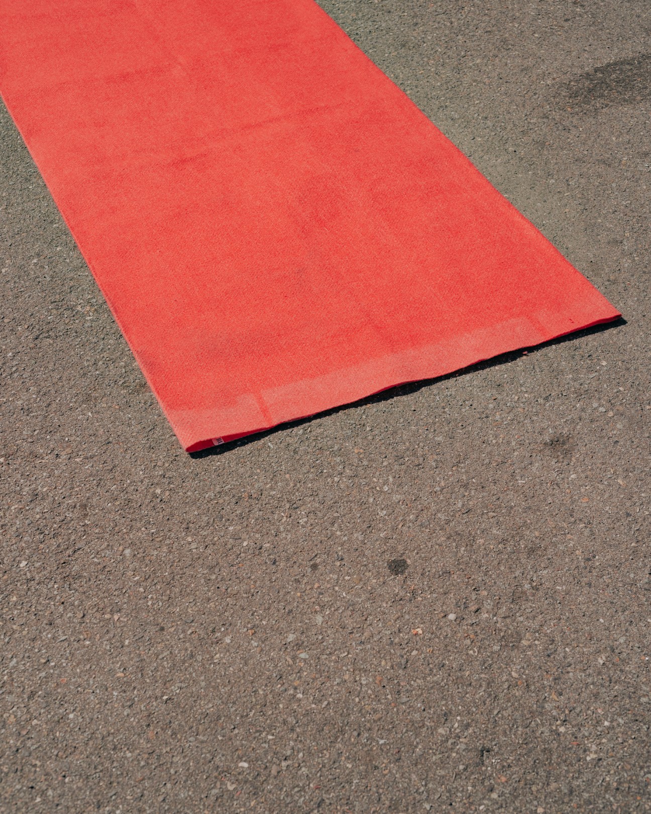 The edge of a red carpet on the tarmac