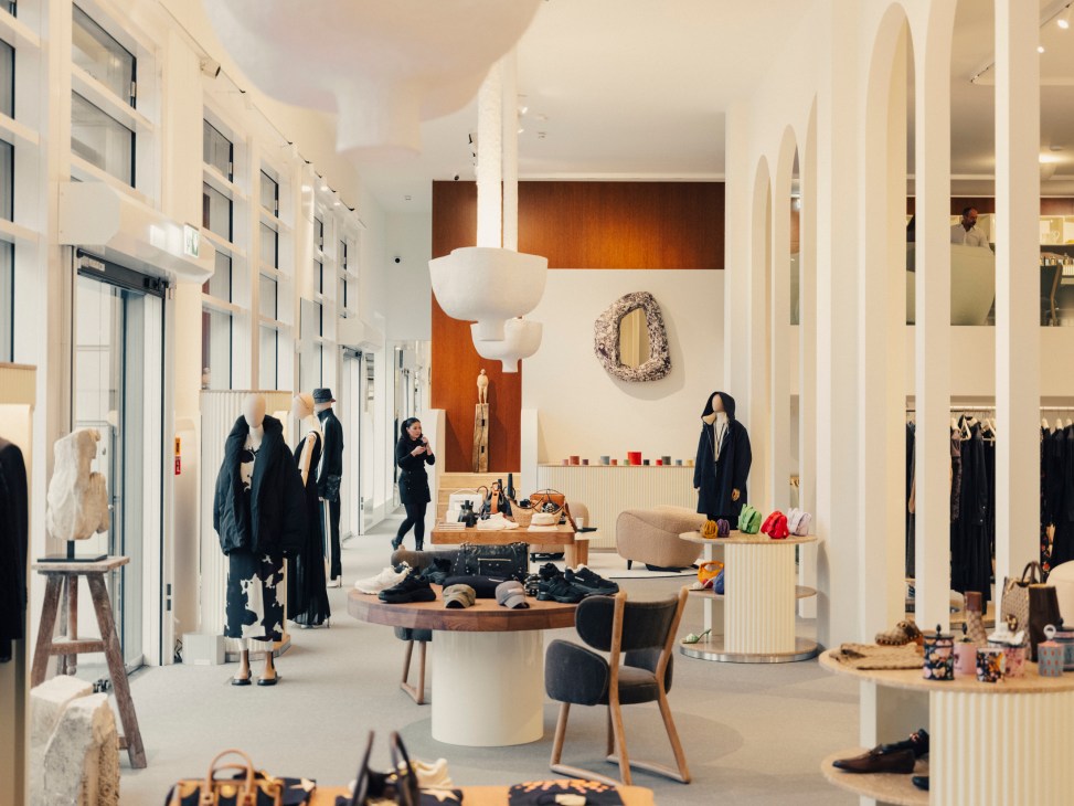 Interior of The Square concept shop in Berlin showing curved sofas, arches, and luxury retail display