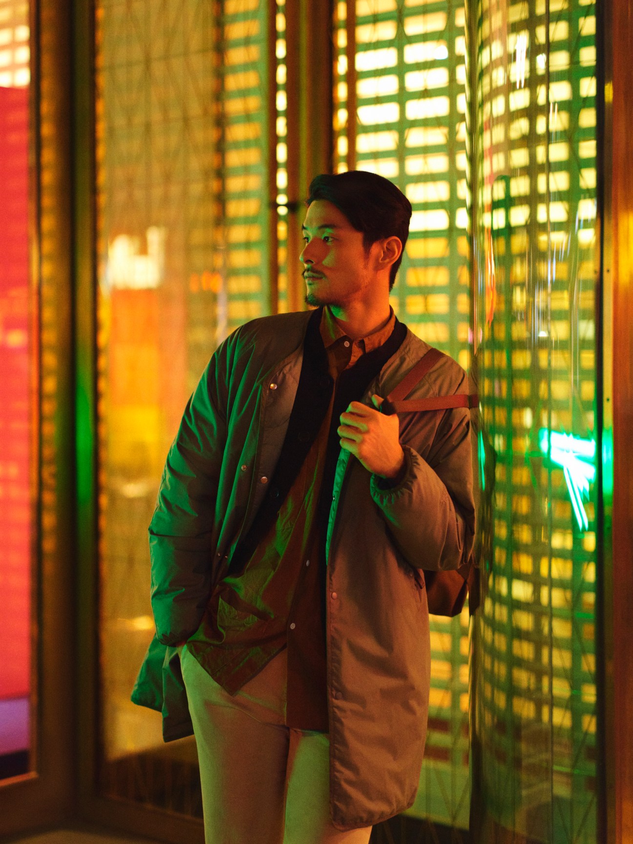 Man in technical coat and shirt with backpack