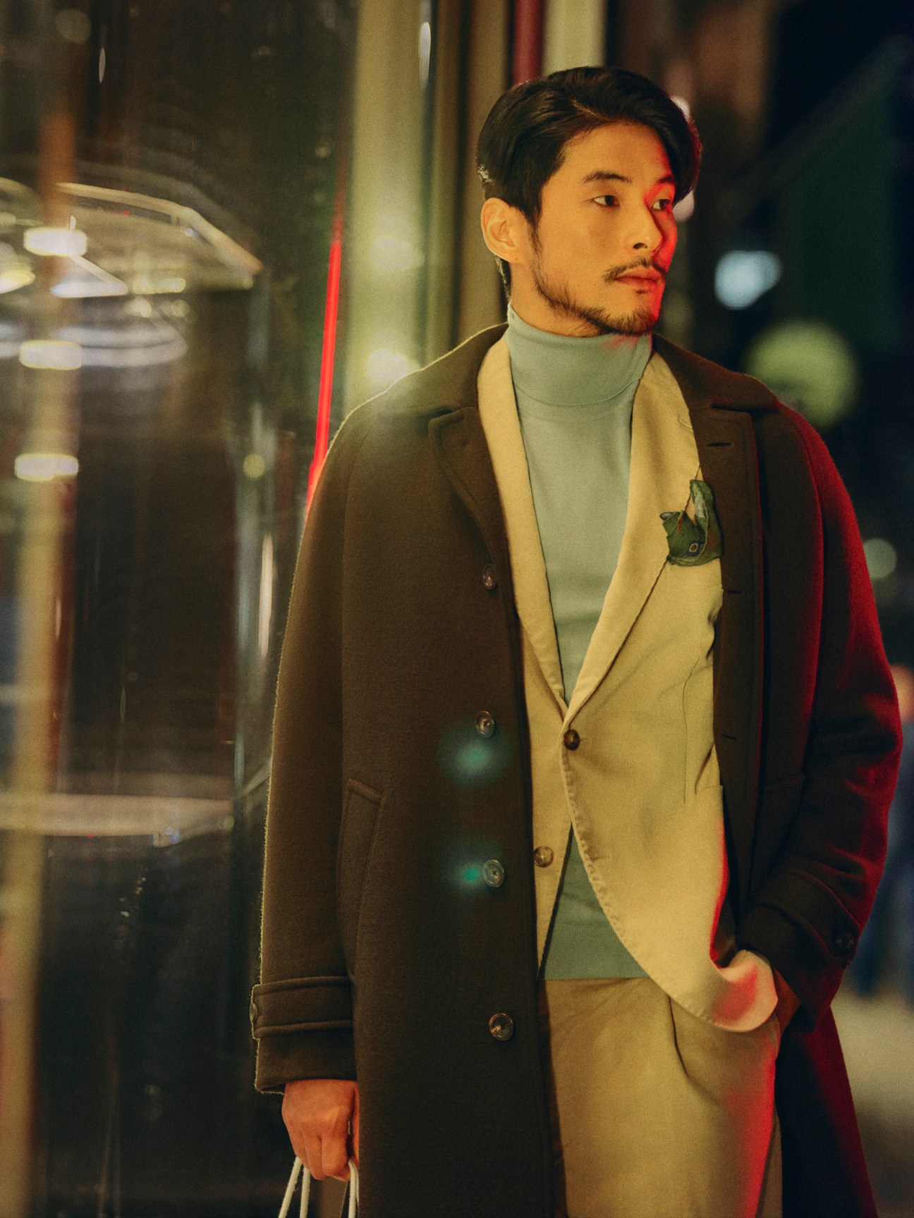 Man in structured coat and suit with rollneck jumper and pocket square