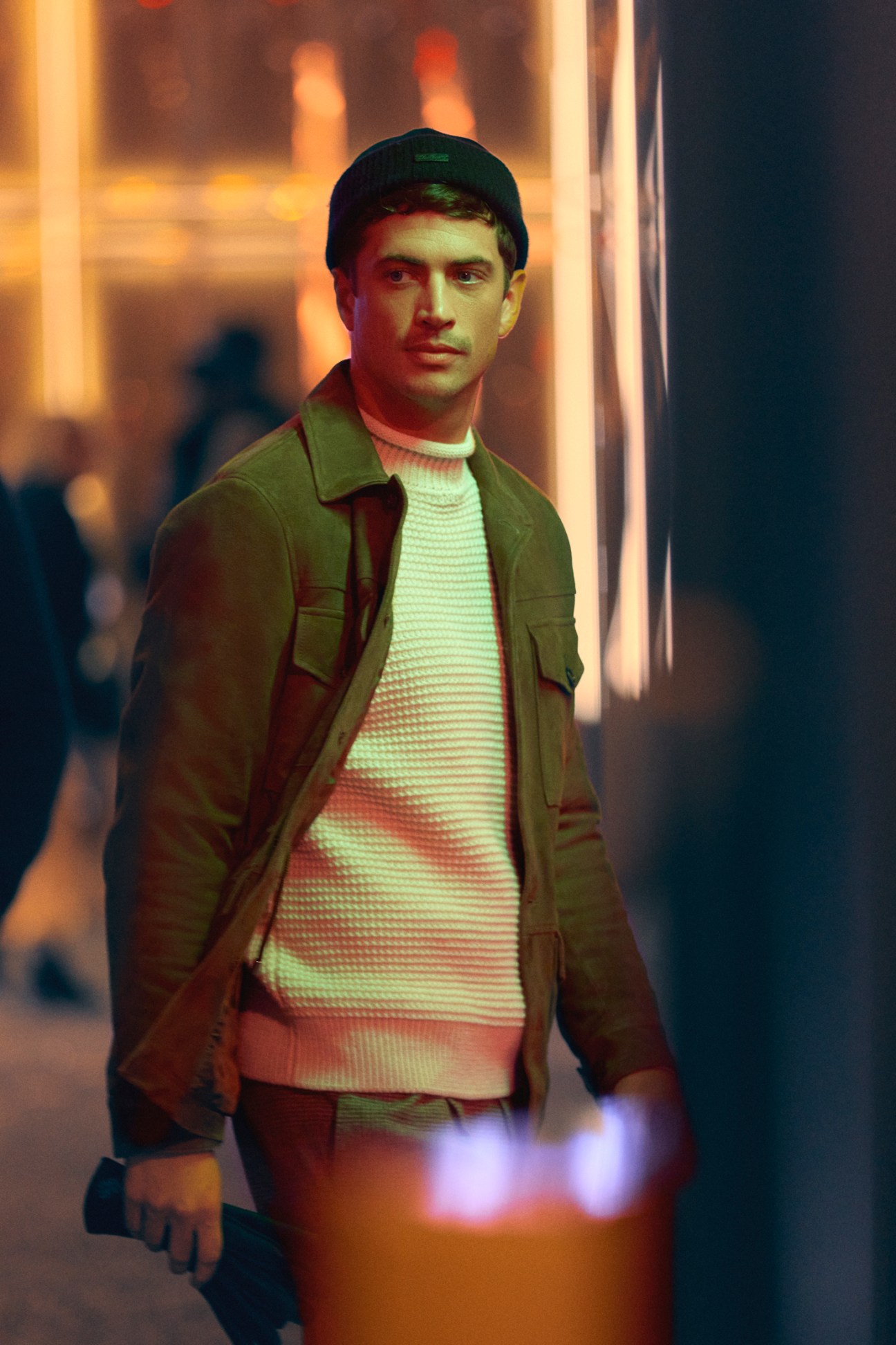 Man in casual jacket and beanie with gloves, wearing a high-neck jumper