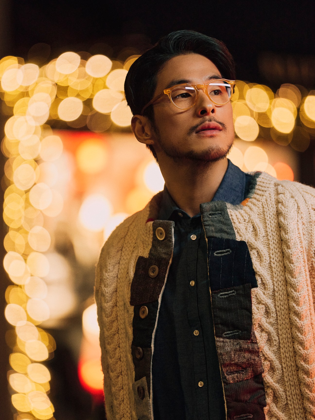 Man wearing cardigan over shirt with glasses