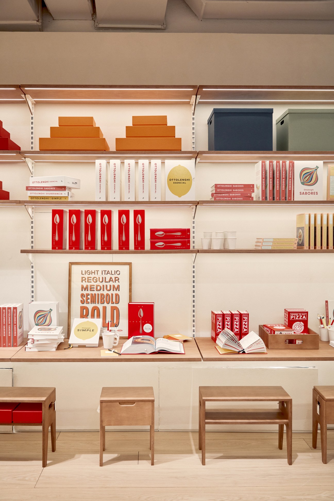 Interior of La Papelería pop-up shop with organized shelving displaying colorful stationery products and typography poster