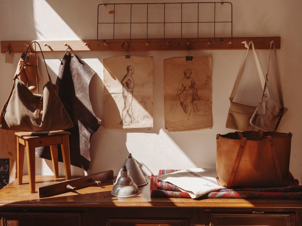 Interior of Charlie Borrow's east London workshop showing leather goods, tools, and crafting equipment