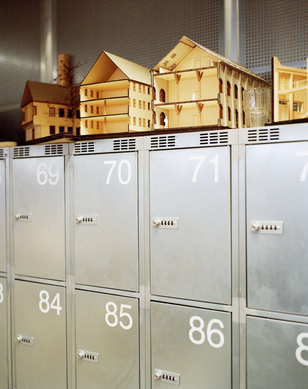 Close-up of numbered metal lockers showing combination locks and numbers 69, 70, 71, 84, 85, 86