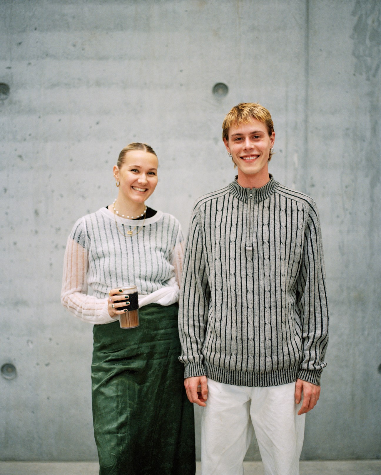 Sofia Skovgaard and Kasper Westergaard, BA architecture students, standing together in front of concrete wall