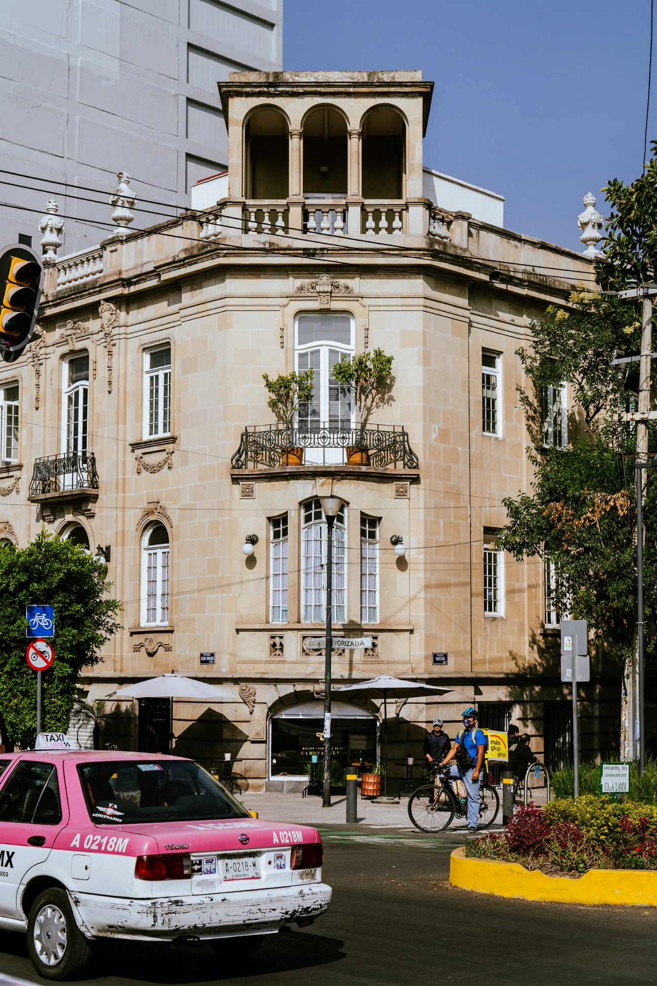 Historic corner building with ornate balconies and arched windows in Mexico City's Roma Norte neighborhood