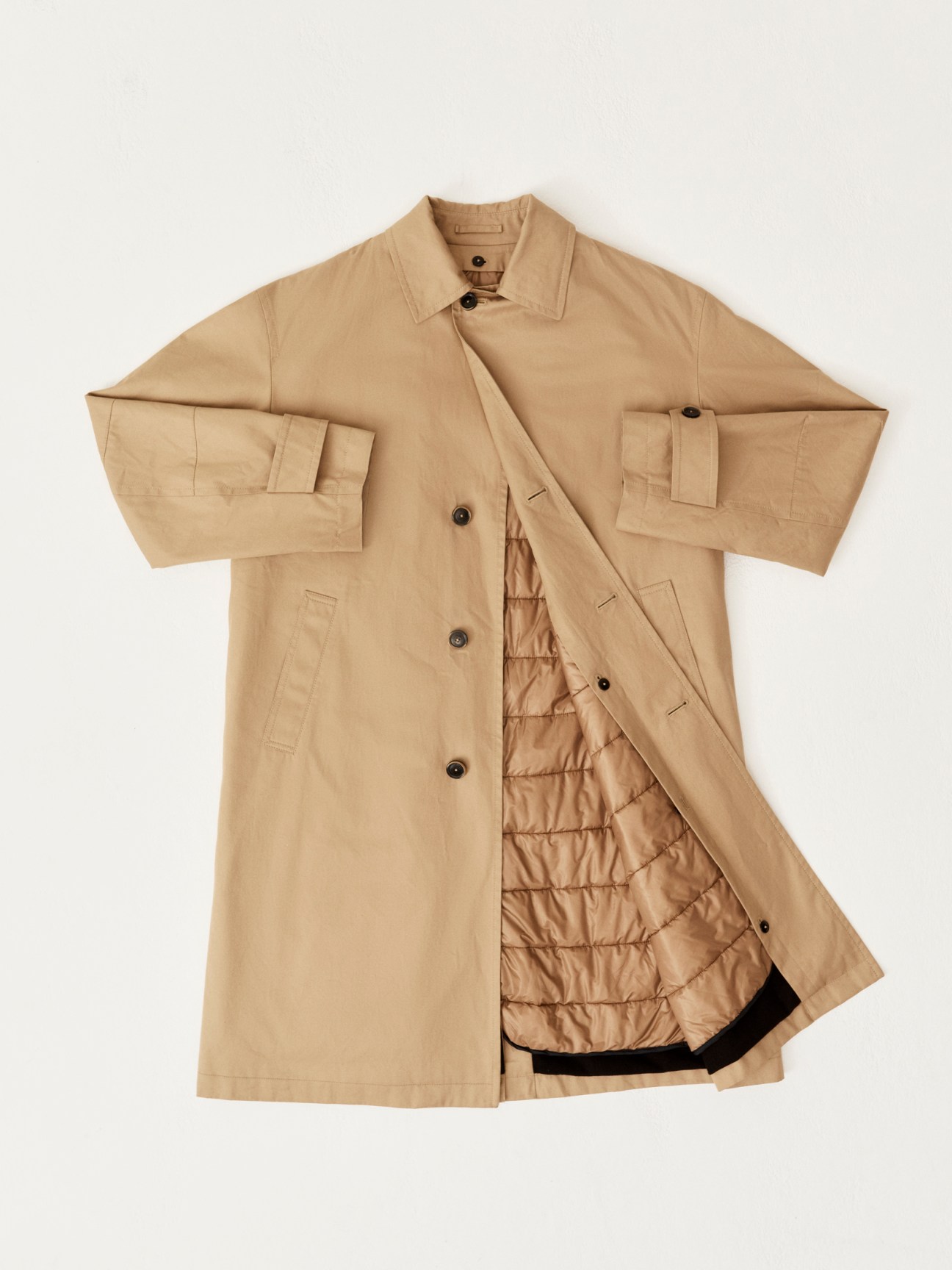 Beige trench coat with quilted lining visible, laid flat showing both exterior and interior details