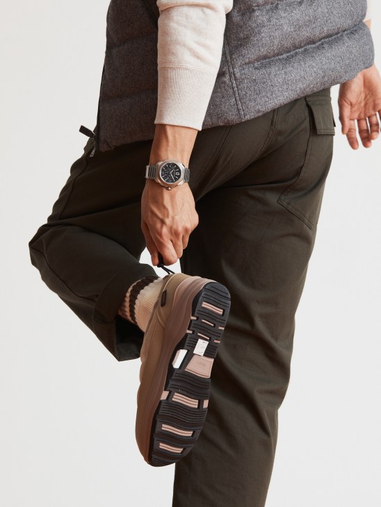 Model's torso showing layered casual clothing with down vest