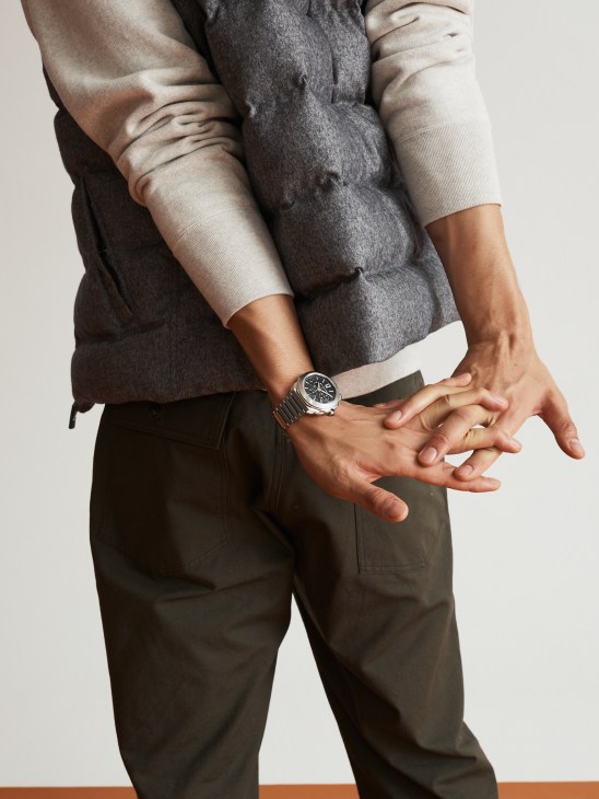 Model wearing casual vest and hoodie combination