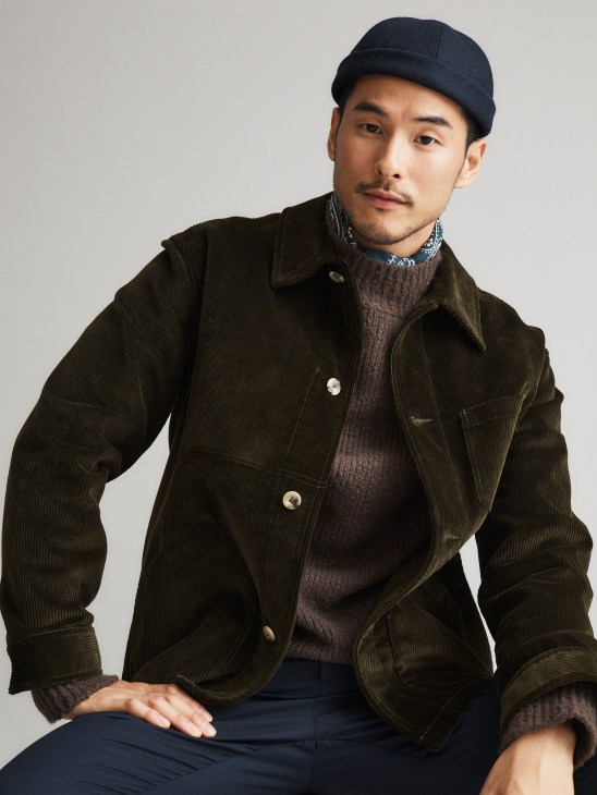 Model in autumn layered look with hat and scarf
