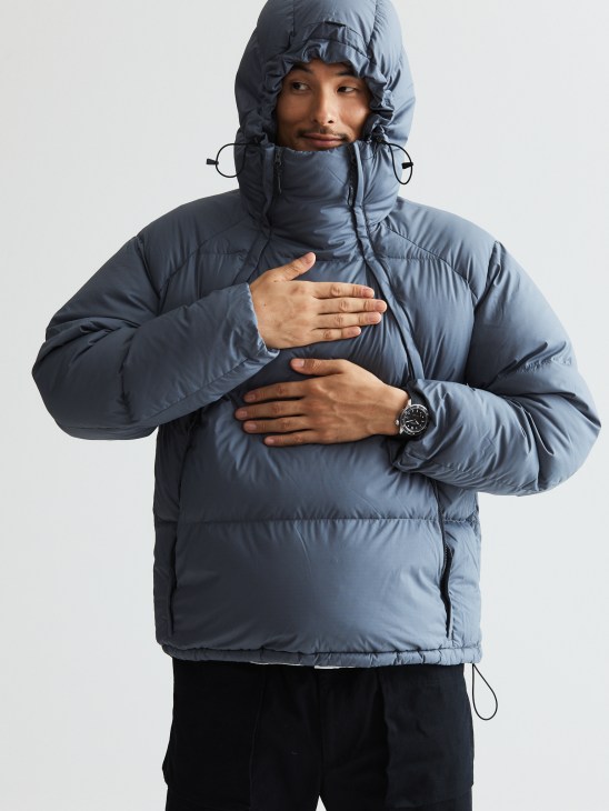 Model in technical down pullover showing watch detail
